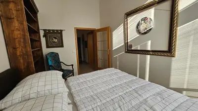 a bedroom with a bed and a mirror and a chair at Grand Prague Residence in Prague