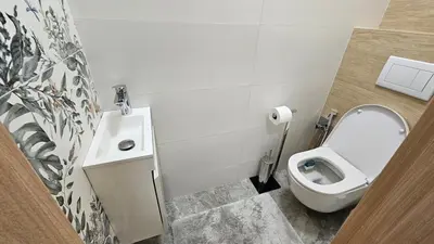 a bathroom with a toilet and a sink at Grand Prague Residence in Prague