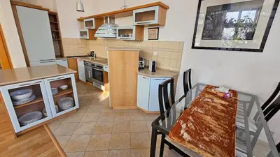 a kitchen with a table and a dining room at Grand Prague Residence in Prague