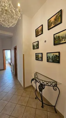 a dining room with a glass table on a wall at Grand Prague Residence in Prague