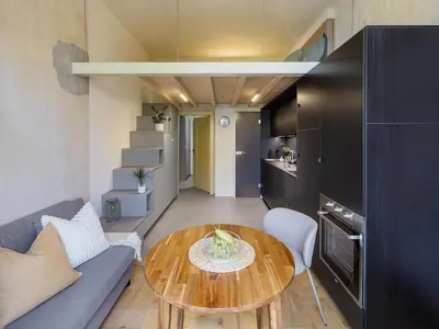 a living room with a table and a couch at Cozy apartment in Vinohrady café & culture zone in Prague