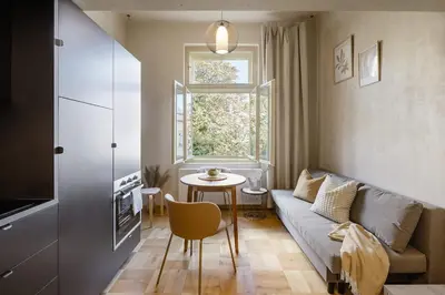 a small living room with a couch and a table at Cozy apartment in Vinohrady café & culture zone in Prague