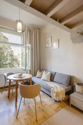 a living room with a couch and a table at Cozy apartment in Vinohrady café & culture zone in Prague