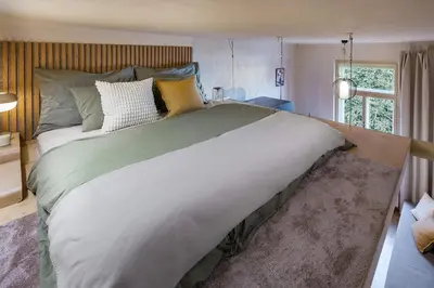 a large bed in a room with a window at Cozy apartment in Vinohrady café & culture zone in Prague