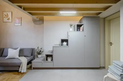 a living room with a couch and a sliding door at Cozy apartment in Vinohrady café & culture zone in Prague