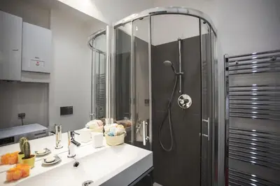 a bathroom with a shower and a sink and a shower at Central river view in Prague