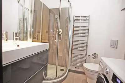 a bathroom with a shower and a toilet and a sink at Central river view in Prague