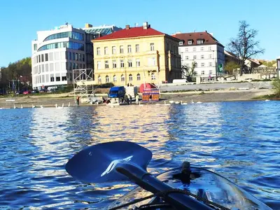 a person in a boat with a whale in the water at Central river view in Prague
