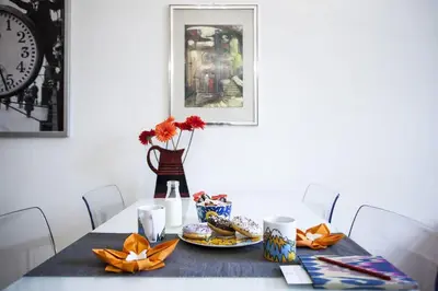 a dining room table with a plate of food and a clock at Central river view in Prague