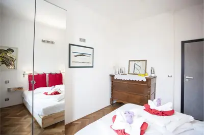 a bedroom with two beds and a mirror at Central river view in Prague