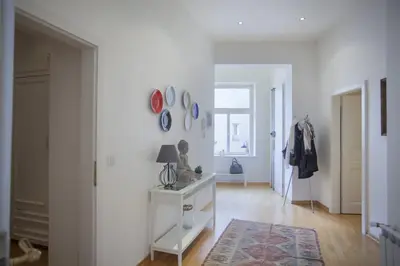 a living room with a white wall with mirrors at Charles Bridge Apartment in Prague
