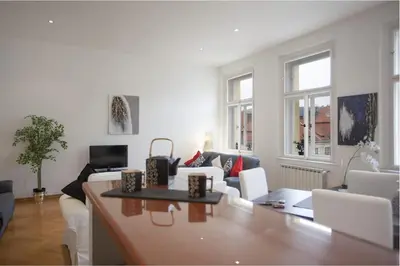 a living room with a couch and a table at Charles Bridge Apartment in Prague