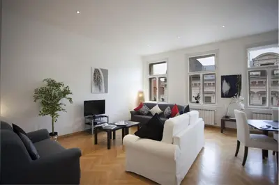 a living room with two couches and a tv at Charles Bridge Apartment in Prague