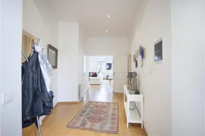 a room with a hallway with white walls and wooden floors at Charles Bridge Apartment in Prague