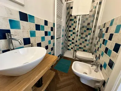 a bathroom with a white sink and a toilet at Luxury flat in Wenceslas Square in Prague