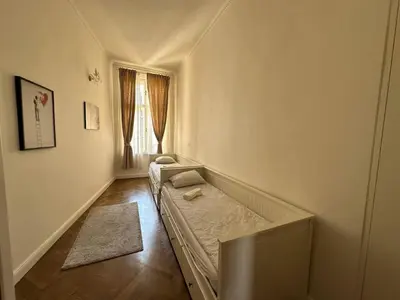 a small room with a bed and a window at Luxury flat in Wenceslas Square in Prague