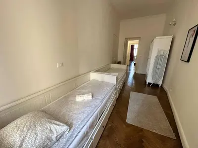 a room with two beds and a refrigerator at Luxury flat in Wenceslas Square in Prague