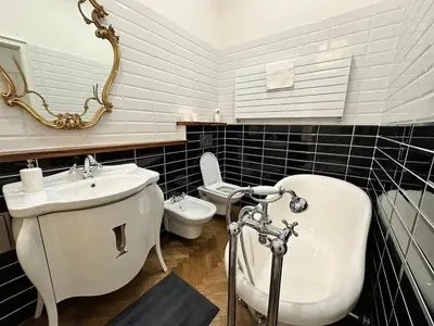 a bathroom with a sink and a tub and a toilet at Luxury flat in Wenceslas Square in Prague