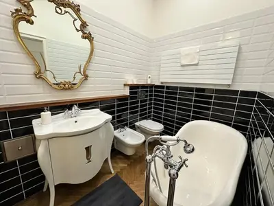 a bathroom with a sink and a tub and a toilet at Luxury flat in Wenceslas Square in Prague