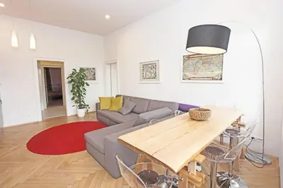 a living room with a couch and a table at Stylish river-view apartment in Prague