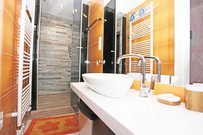 a bathroom with a sink and a shower at Stylish river-view apartment in Prague
