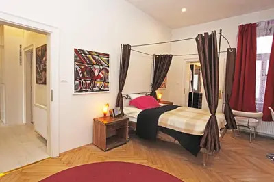 a bedroom with a canopy bed in a room at Stylish river-view apartment in Prague