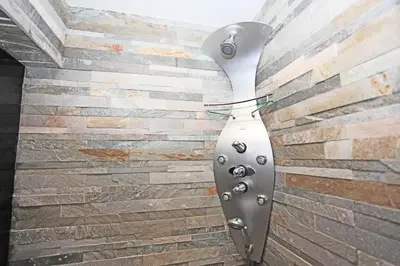 a light on a brick wall at Stylish river-view apartment in Prague