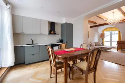 a kitchen and dining room with a table and chairs at Charles bridge unique maisonette in Prague