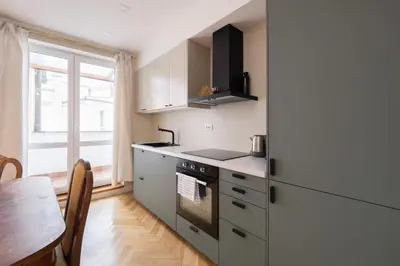 a kitchen with a stove and a table and a window at Charles bridge unique maisonette in Prague