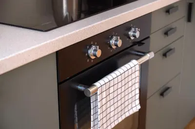 a towel is hanging on an oven in a kitchen at Charles bridge unique maisonette in Prague