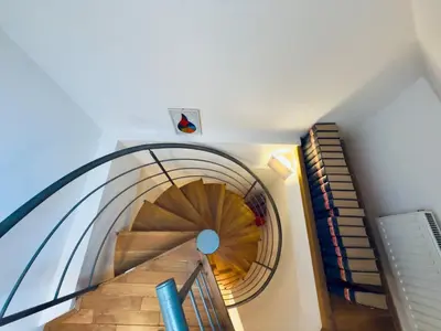 a spiral staircase in a building with a spiral at Attic 15 min to Charles Bridge in Prague