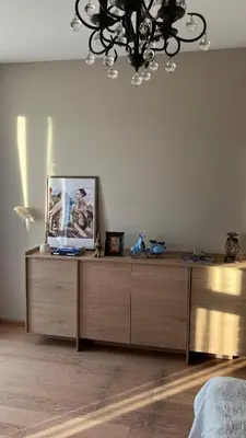 a room with a dresser with a picture on it at Riverside serenity Modern apartment with sunset views in Prague