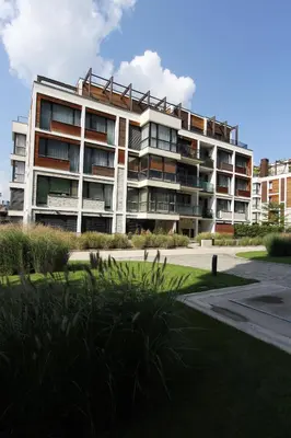 a large apartment building with a lot of windows at Riverside serenity Modern apartment with sunset views in Prague