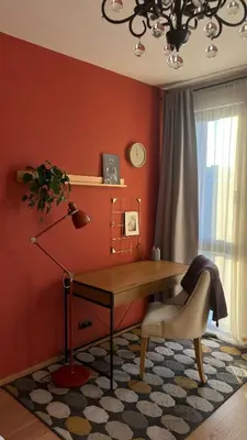 a desk with a lamp and a chair in a room at Riverside serenity Modern apartment with sunset views in Prague