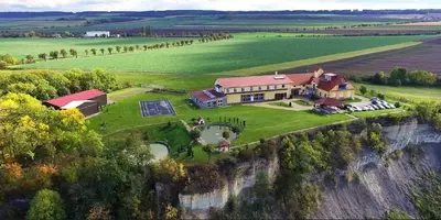 an aerial view of a large house on a cliff at Wellness resort Kytra in Slavětín
