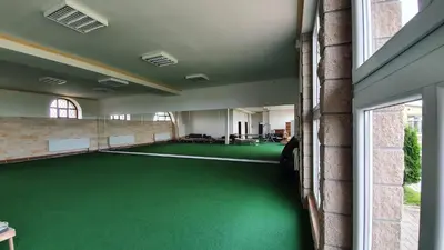 a room with a green floor in a building at Wellness resort Kytra in Slavětín