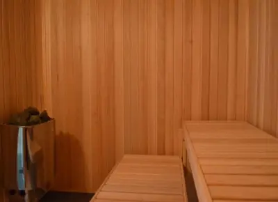 a corner of a sauna with two wooden shelves at Wellness resort Kytra in Slavětín