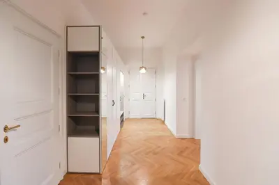 an empty hallway with a mirror and a closet at Elegant Garden Apartment near Main Station in Prague