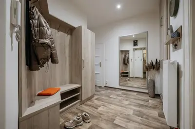 a room with a walk in closet and a refrigerator at Spacious 2BR Vršovice | AC • Netflix • Cozy Stay in Prague