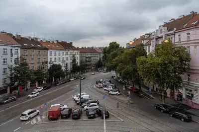 a city street with cars parked in a parking lot at Spacious 2BR Vršovice | AC • Netflix • Cozy Stay in Prague