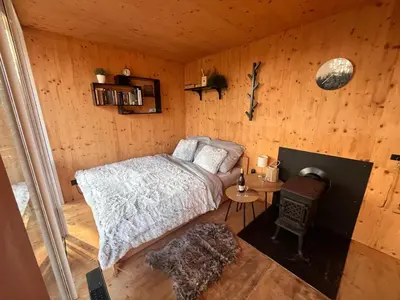 a bedroom with a bed in a wooden cabin at Tinyhouse Veranda