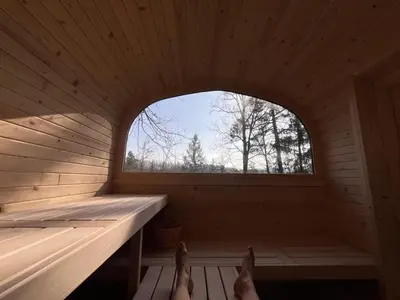 a persons feet in a sauna with a window at Tinyhouse Veranda