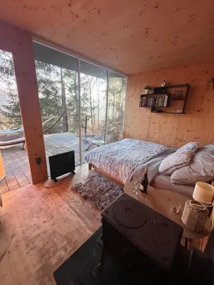 a bedroom with a bed and a large window at Tinyhouse Veranda
