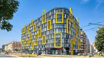 a yellow and gray building on a city street at Centre Design Suite O2 Arena - Parking-Balcony-big TV-Coffee, 24 7 Self Check-in in Prague