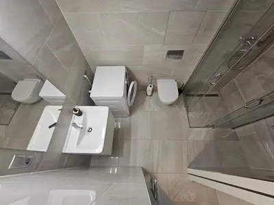 a bathroom with three toilets and three sinks at Centre Design Suite O2 Arena - Parking-Balcony-big TV-Coffee, 24 7 Self Check-in in Prague