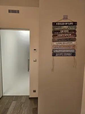 a sign hanging on a wall next to a door at Centre Design Suite O2 Arena - Parking-Balcony-big TV-Coffee, 24 7 Self Check-in in Prague