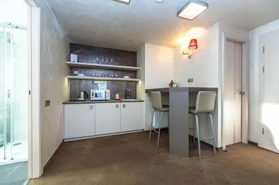a kitchen with a counter and chairs in a room at Residence Mysterius Old Town in Prague