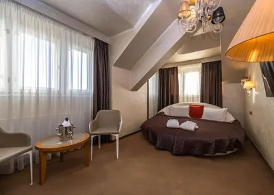 a bedroom with a bed and a table and chairs at Residence Mysterius Old Town in Prague