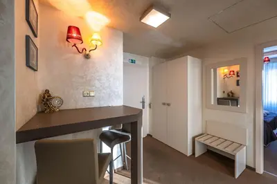 a room with a dining table and a bedroom at Residence Mysterius Old Town in Prague