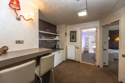 a kitchen with a counter and chairs in a room at Residence Mysterius Old Town in Prague
